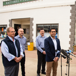 Men standing in front of microphones